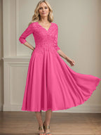 Vestido de corte A, escote en V, largo hasta la rodilla, de gasa, encaje, con lentejuelas y pedrería para la madre de la novia. 