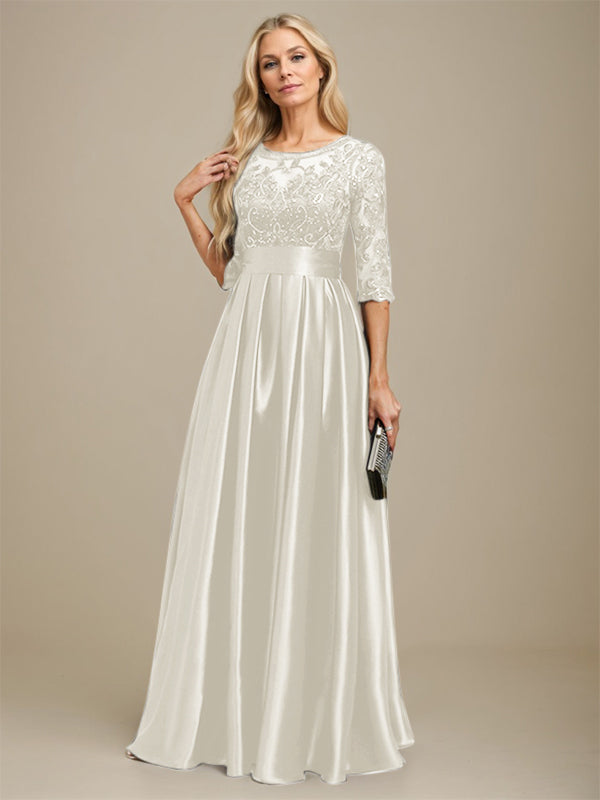 Robe de mariée longue en satin stretch dentelle et dentelle, coupe trapèze, décolleté illusion, ornée d'un nœud à sequins 