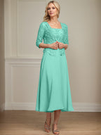 Vestido de corte A, largo midi, de gasa, encaje y lentejuelas para la madre de la novia. 