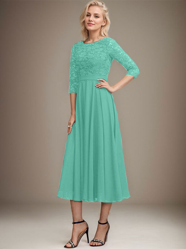 Vestido de novia de corte línea A, escote redondo, largo hasta la rodilla, de encaje y gasa con lentejuelas.