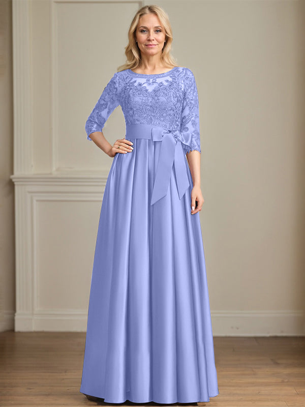 Vestido de novia corte A, escote ilusión, largo hasta el suelo, de satén y encaje, con lazo de lentejuelas. 