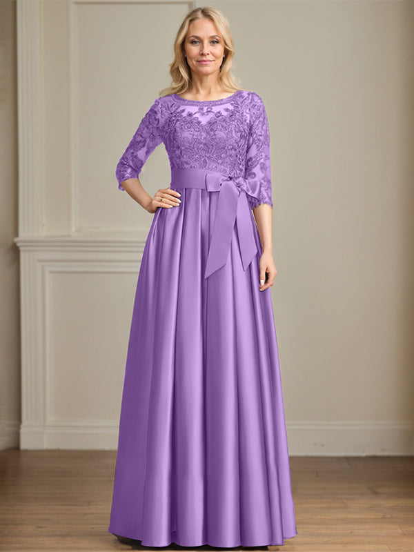 Vestido de novia corte A, escote ilusión, largo hasta el suelo, de satén y encaje, con lazo de lentejuelas. 