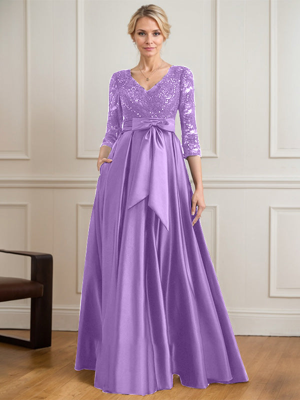 Vestido de novia de satén con encaje, corte en A, escote en V y largo hasta el suelo, con lazo de lentejuelas. 