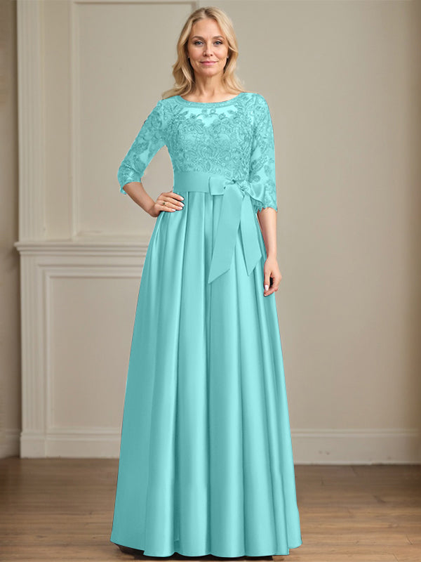 Vestido de novia corte A, escote ilusión, largo hasta el suelo, de satén y encaje, con lazo de lentejuelas. 