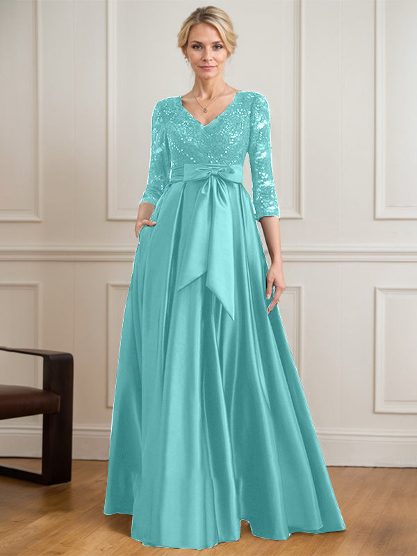 Vestido de novia de satén con encaje, corte en A, escote en V y largo hasta el suelo, con lazo de lentejuelas. 
