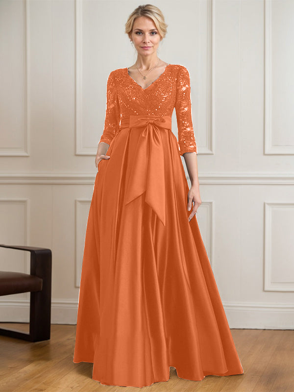 Vestido de novia de satén con encaje, corte en A, escote en V y largo hasta el suelo, con lazo de lentejuelas. 