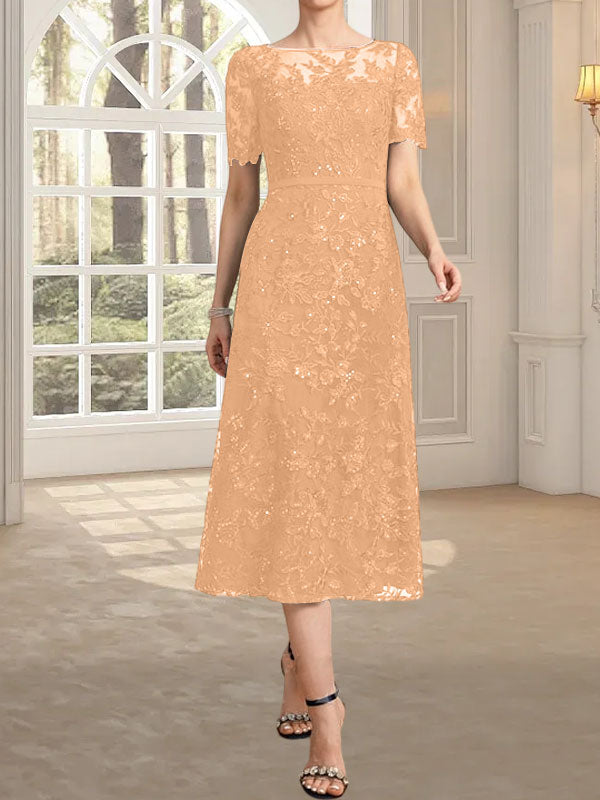 Vestido de novia de encaje con lentejuelas, corte en A, escote redondo ilusión y largo hasta la rodilla.