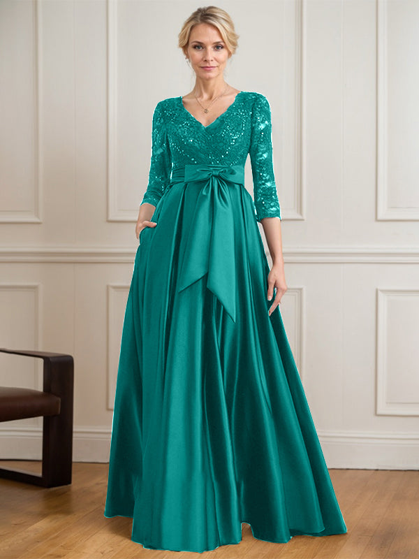 Vestido de novia de satén con encaje, corte en A, escote en V y largo hasta el suelo, con lazo de lentejuelas. 