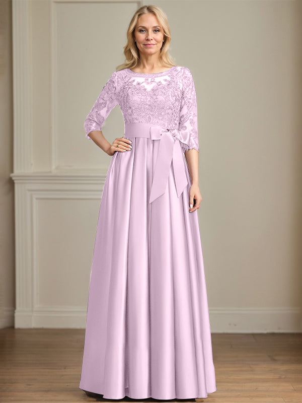 Vestido de novia corte A, escote ilusión, largo hasta el suelo, de satén y encaje, con lazo de lentejuelas. 