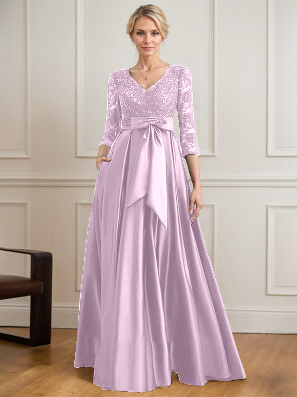 Vestido de novia de satén con encaje, corte en A, escote en V y largo hasta el suelo, con lazo de lentejuelas. 