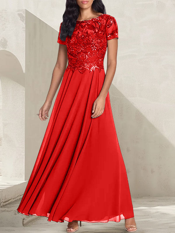 Vestido largo de corte A, color gris carbón, con escote redondo y detalles de pedrería, ideal para la madre de la novia.