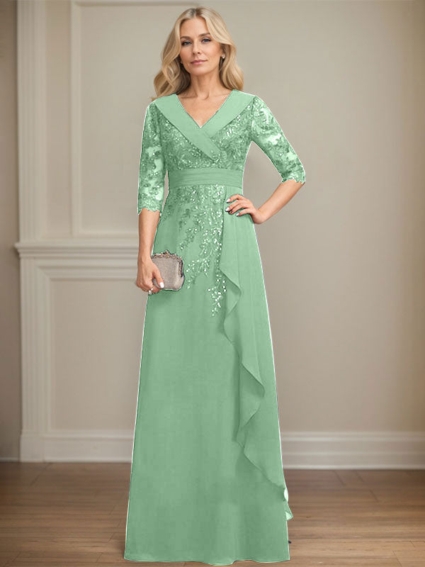 Vestido de novia de corte línea A, cuello en V, largo hasta el suelo, de encaje y gasa, con lentejuelas y volantes en cascada. 