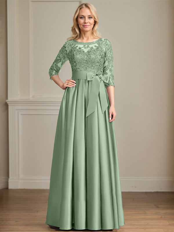 Vestido de novia corte A, escote ilusión, largo hasta el suelo, de satén y encaje, con lazo de lentejuelas. 