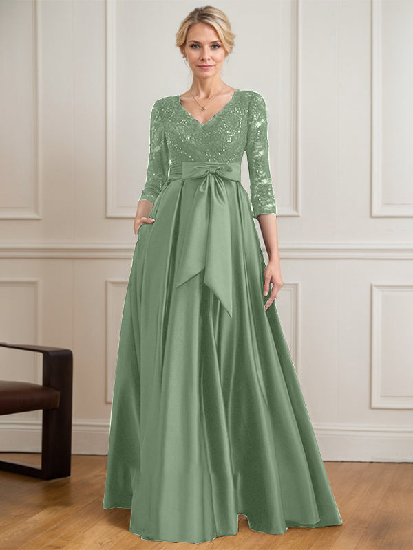 Vestido de novia de satén con encaje, corte en A, escote en V y largo hasta el suelo, con lazo de lentejuelas. 