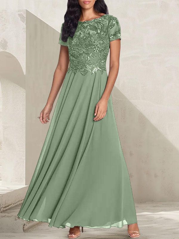 Vestido largo de corte A, color gris carbón, con escote redondo y detalles de pedrería, ideal para la madre de la novia.