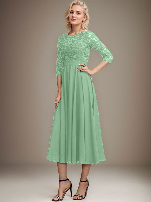 Vestido de novia de corte línea A, escote redondo, largo hasta la rodilla, de encaje y gasa con lentejuelas.