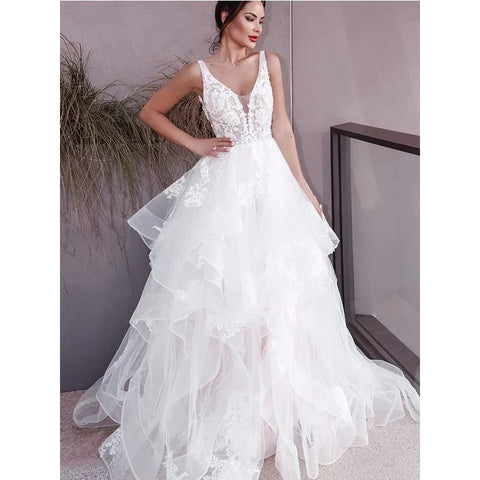 Vestidos de novia blancos sin mangas, estilo bohemio, con escote en V, doble hombro y espalda descubierta. Ideales para bodas formales en la playa. Colección 2023.