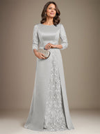 Robe de mère de la mariée en satin de dentelle, coupe trapèze, longue jusqu'au sol, ornée d'appliqués, avec décolleté plongeant et bretelles.