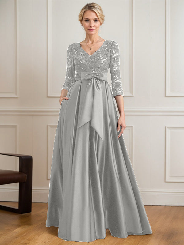 Vestido de novia de satén con encaje, corte en A, escote en V y largo hasta el suelo, con lazo de lentejuelas. 
