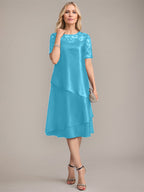 Vestido de corte A, escote redondo, largo hasta la rodilla, para la madre de la novia, con apliques y lentejuelas. 