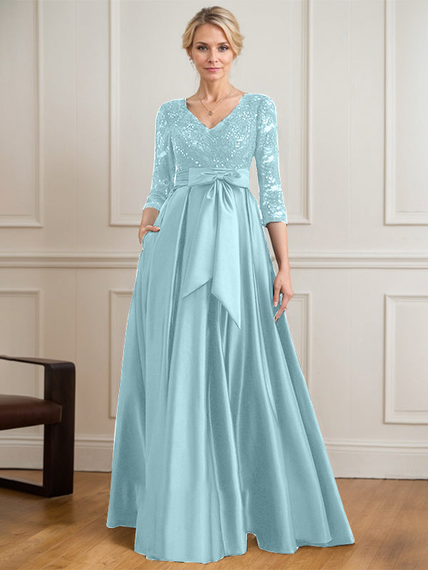 Vestido de novia de satén con encaje, corte en A, escote en V y largo hasta el suelo, con lazo de lentejuelas. 