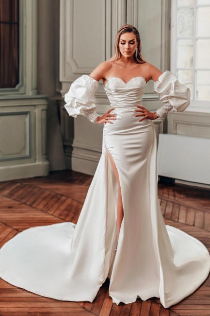 Vestidos de novia de corte A con escote corazón, abertura frontal, manga larga y volantes.