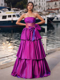 Robe de bal bustier transparent à nœud sur le devant, ornée de cristaux et sans bretelles, à volants étagés