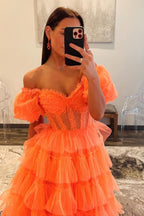Robe de bal longue en tulle à épaules dénudées, coupe trapèze, bustier à volants et fente.