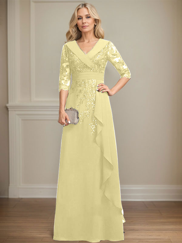 Vestido de novia de corte línea A, cuello en V, largo hasta el suelo, de encaje y gasa, con lentejuelas y volantes en cascada. 