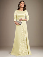 Robe de mère de la mariée en satin de dentelle, coupe trapèze, longue jusqu'au sol, ornée d'appliqués, avec décolleté plongeant et bretelles.