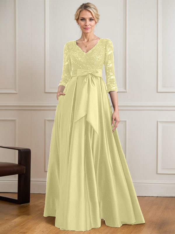 Vestido de novia de satén con encaje, corte en A, escote en V y largo hasta el suelo, con lazo de lentejuelas. 