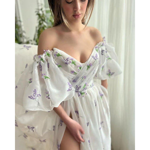 Vestido largo de fiesta con escote barco, abertura lateral y bolsillos. 