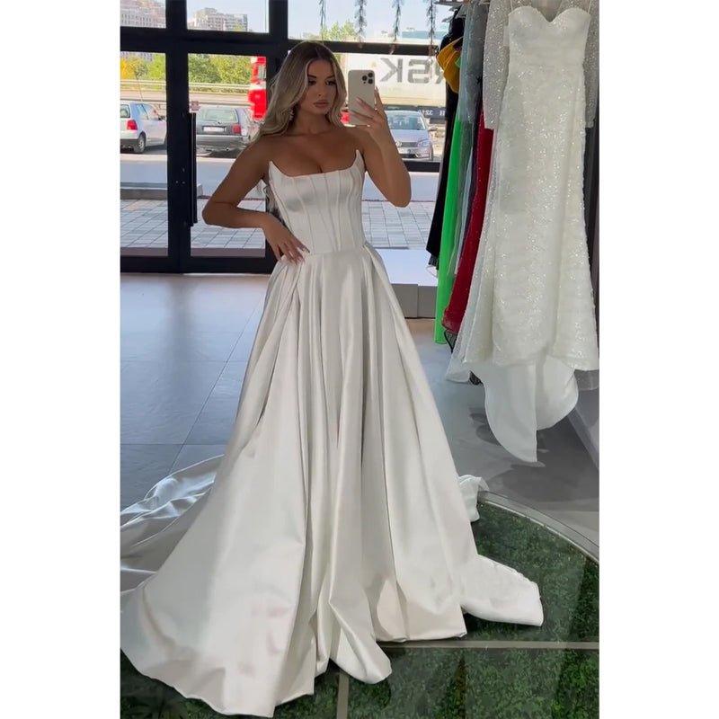 Vestido largo de fiesta blanco satinado sin tirantes, corte en A, con cola 