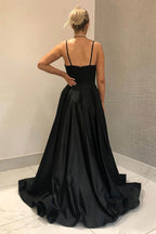 Vestido largo de fiesta negro de corte A con tirantes finos y falda asimétrica.