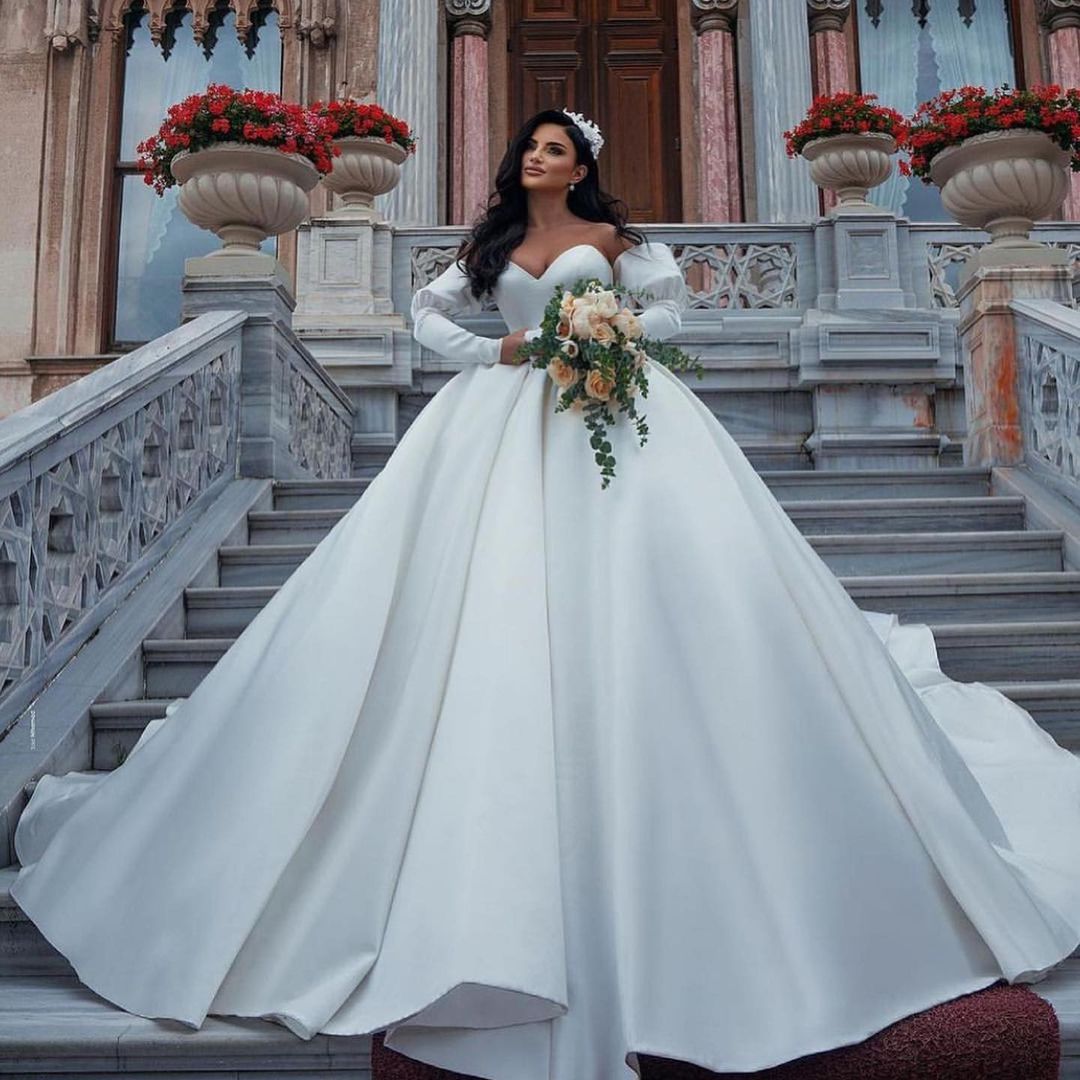 Impresionantes vestidos de novia largos de princesa, de satén, con escote corazón y mangas.