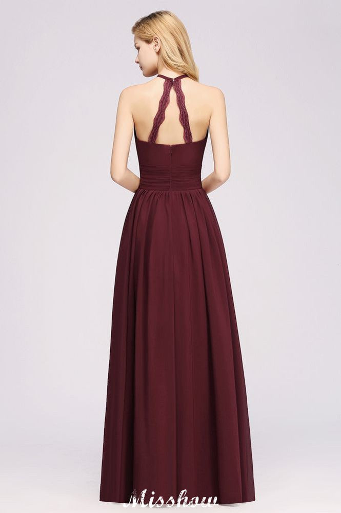 Vestido largo de noche de gasa con apliques, cuello halter, sin mangas y largo hasta el suelo, con volantes y corte en A.