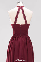 Vestido largo de noche de gasa con apliques, cuello halter, sin mangas y largo hasta el suelo, con volantes y corte en A.