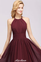 Vestido largo de noche de gasa con apliques, cuello halter, sin mangas y largo hasta el suelo, con volantes y corte en A.