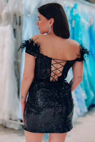 Robe de bal courte noire à paillettes et épaules dénudées, ornée de plumes, style fourreau glamour et scintillant.