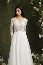 Robe de mariée longue en mousseline et dentelle, coupe trapèze, décolleté cœur et manches, Biztunnel