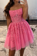 Magnifique robe de bal rose bustier sans bretelles, coupe trapèze, ornée d'appliqués