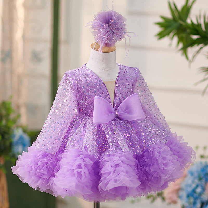 Vestido de bebé niña color lila con lentejuelas, mangas largas con volantes y lazo hasta la rodilla 