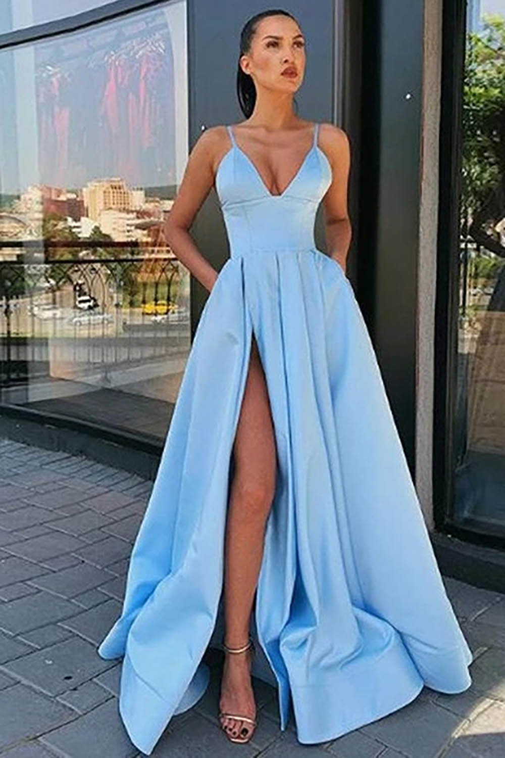 Vestido largo de fiesta negro de corte A con tirantes finos y falda asimétrica.