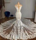 Robe de mariée sirène de luxe en tulle à col bijou et perles, ornée d'appliqués de dentelle.