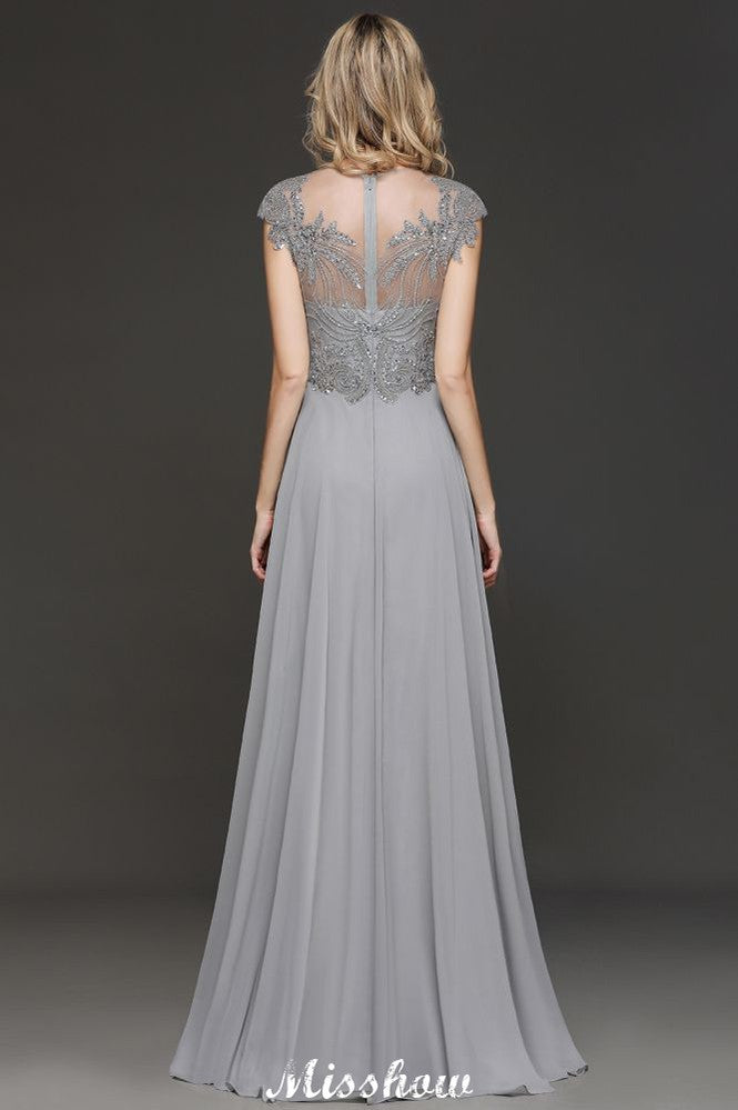 Robe de soirée maxi dos nu à encolure cœur et fente latérale ornée de cristaux, coupe trapèze, idéale pour un mariage ou une fête.