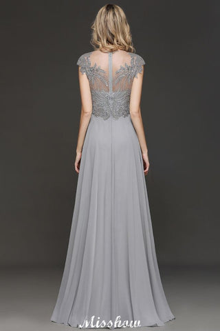 Robe de soirée maxi dos nu à encolure cœur et fente latérale ornée de cristaux, coupe trapèze, idéale pour un mariage ou une fête.