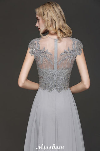 Robe de soirée maxi dos nu à encolure cœur et fente latérale ornée de cristaux, coupe trapèze, idéale pour un mariage ou une fête.