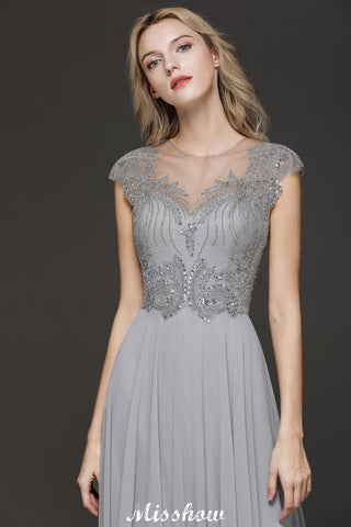 Robe de soirée maxi dos nu à encolure cœur et fente latérale ornée de cristaux, coupe trapèze, idéale pour un mariage ou une fête.