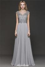 Robe de soirée maxi dos nu à encolure cœur et fente latérale ornée de cristaux, coupe trapèze, idéale pour un mariage ou une fête.