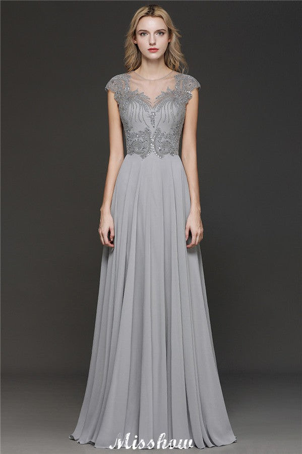 Robe de soirée maxi dos nu à encolure cœur et fente latérale ornée de cristaux, coupe trapèze, idéale pour un mariage ou une fête.